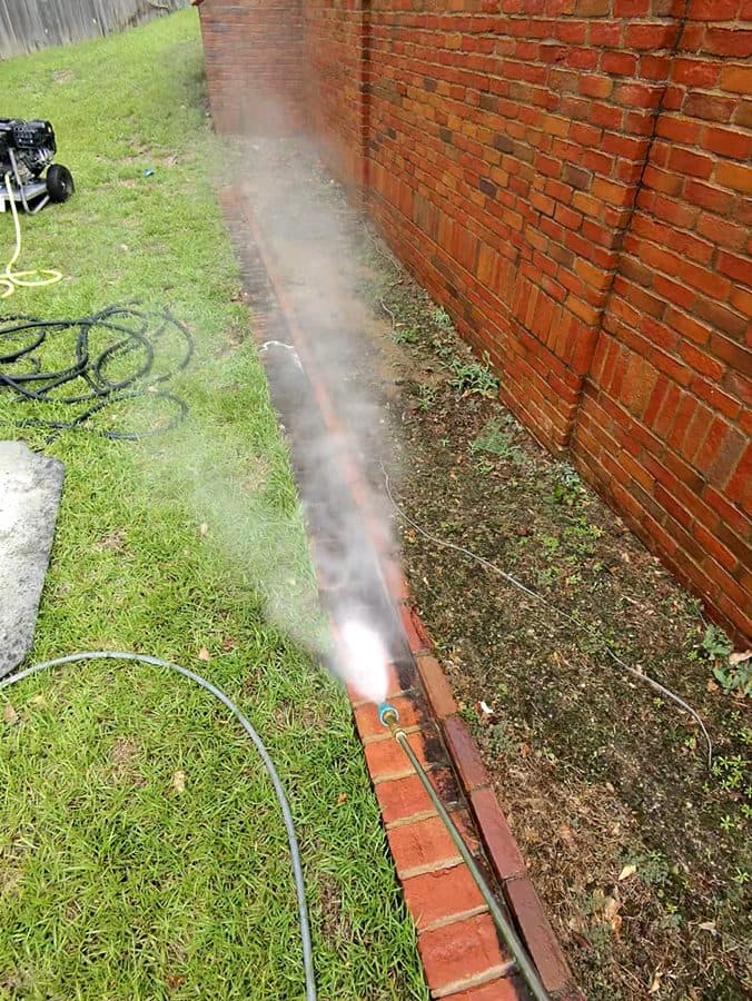 Brick and siding home exterior being cleaned by Team Clean in the Columbus, GA area