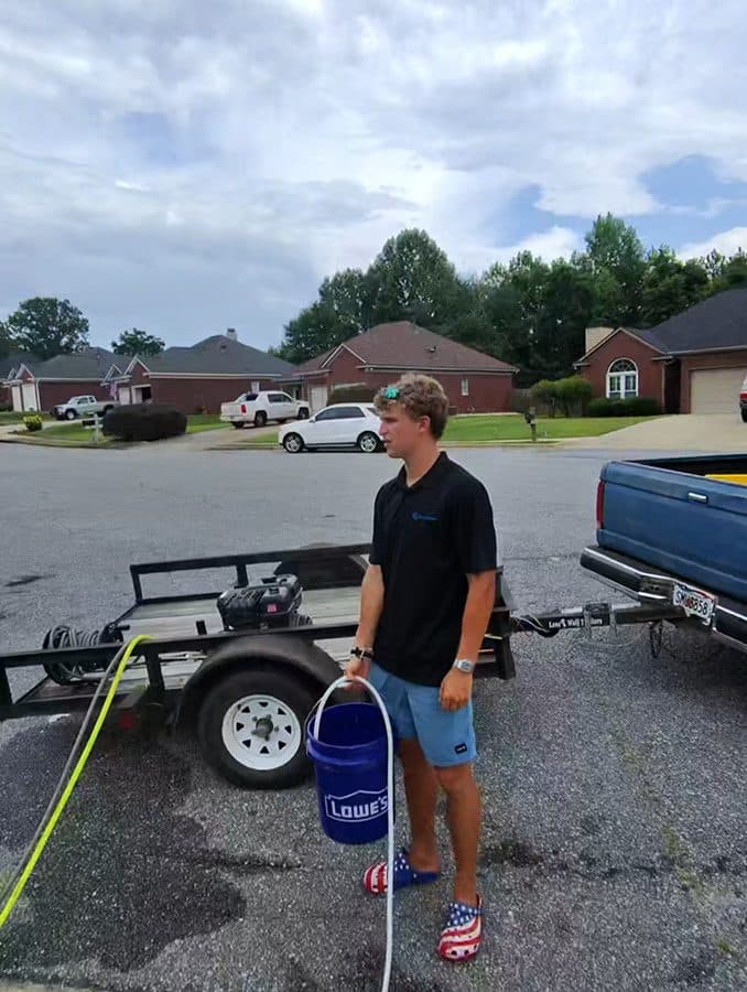Team Clean team member with the work truck and trailer in a Columbus GA area neighborhood