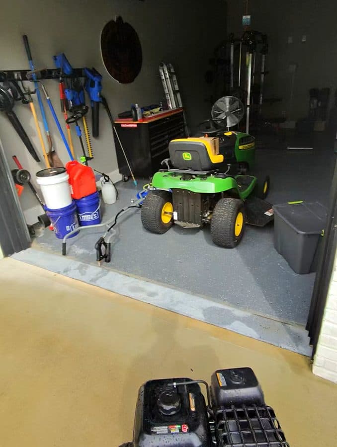 Pressure washing equipment staged in a garage before exterior cleaning work
