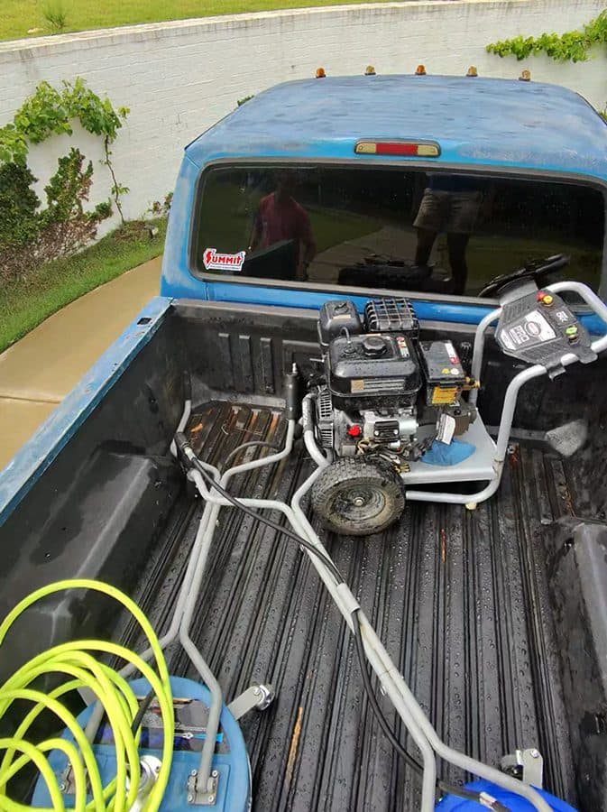 Pressure washing equipment loaded in a truck bed before a job