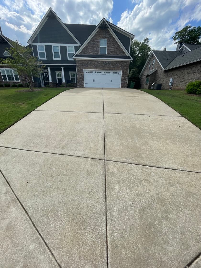 Clean concrete driveway after Team Clean pressure washing